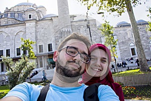Happy muslim cuople taking selfie in front on Fatih mosque in Istanbul