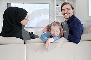 Happy Muslim family having fun at home