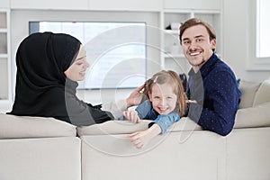 Happy Muslim family having fun at home