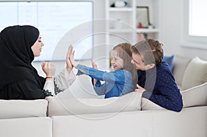 Happy Muslim family having fun at home