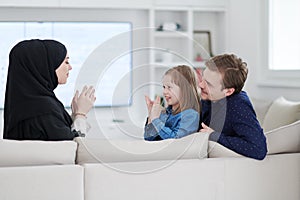 Happy Muslim family having fun at home