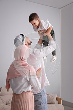 Happy Muslim family spending time together at home