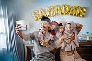 happy muslim family take selfie together in ramadan