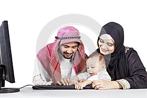 Happy muslim family using a computer together