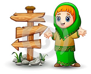 Happy Muslim girl presenting with blank wood arrow sign