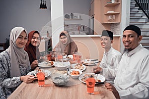 Happy muslim having dinner at home break fasting on ramadan