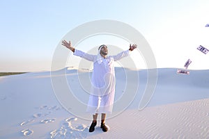 Happy Muslim man looks through banknotes and beside himself with