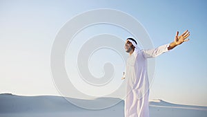 Happy Muslim man looks through banknotes and beside himself with