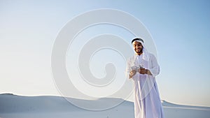 Happy Muslim man looks through banknotes and beside himself with