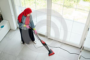 Happy Muslim Woman Cleaning Modern House Living Room