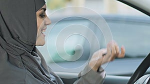 Happy Muslim woman holding keys, rights of female drivers in Islam, car purchase