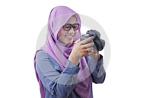 Happy Muslim Woman Photographer Holding a Camera and Smiling