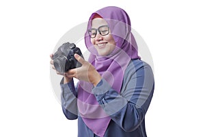 Happy Muslim Woman Photographer Holding a Camera and Smiling