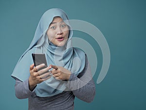 Happy Muslim Woman Pointing on Her Smart Phone