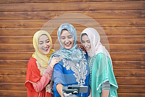 Happy muslim women making video with gimbal smart phone camera in college - Arabian young people having fun with new technology