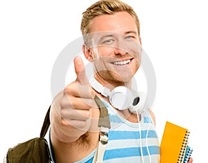 Happy with my degree choice. a handsome young student standing alone in the studio and carrying his textbooks while