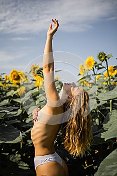 Happy Naked Blonde Woman In A Field Of Sunflowers.