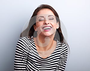 Happy natural toothy laughing casual woman with wide open mouth