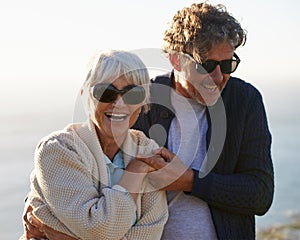Happy, nature and senior couple with love for travel, tourism and holiday in retirement together. Coast, field and