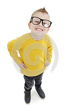 Happy nerdy boy in glasses smiling looking at camera on white background . Closeup portrait of funny school kid in glasses