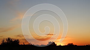 Happy new day concept: summer sunrise over beautiful field and stunning sky