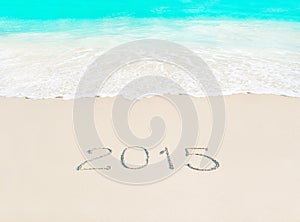 Happy New Year 2015 season concept on azure tropical sandy beach