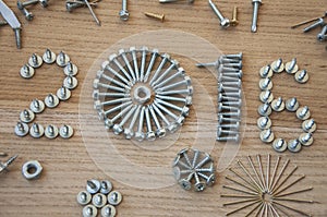 Happy new year 2016 composition with screws nails bolts and dowels