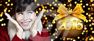 Happy new year 2016, woman looks up on lights background