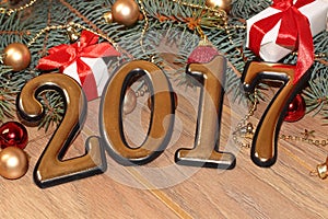 Happy new year 2017 gold figures on the wooden background