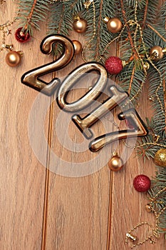 Happy new year 2017 gold figures on the wooden background with Christmas decorations close, balls and gifts