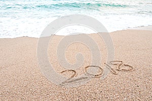 Happy new year 2018 concept. Number 2018 written on sandy beach