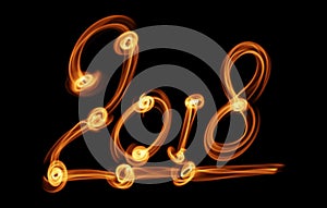 Happy new year 2018 isolated numbers lettering written with fire flame or smoke on black background