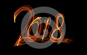 Happy new year 2018 isolated numbers lettering written with fire flame or smoke on black background