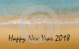 Happy New Year 2018 message written on idyllic tropical beach
