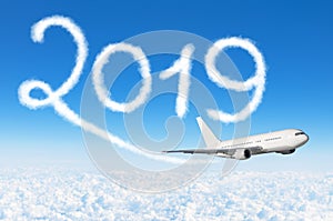 Happy New year 2019 concept travel. Drawing by passenger airplane vapor contrail in sky