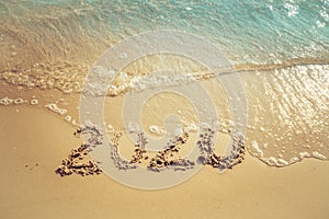 Happy New Year 2020 concept, 2020 number lettering on the sea beach.