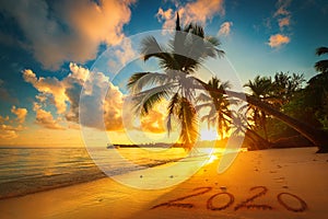 Happy New Year 2020 concept, lettering on the beach. Sea sunrise