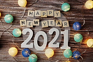 Happy New Year 2021 decorate with LED cotton ball on wooden background