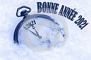 Happy New Year 2021 greeting in French language, bonne annee text, pocket watch