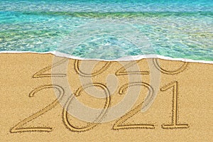 Happy New Year 2021 and leaving year of 2020 concept text on the sea beach