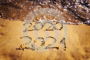 Happy new year 2021 text by the sea. Selective focus. Abstract background photography of the approaching New Year 2021 and the out