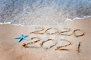 Happy new year 2021 text by the sea. Selective focus. Abstract background photography of the approaching New Year 2021 and the out
