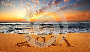 Happy New Year 2021! Written 2021 on the beach. Happy New Year 2021 is coming concept sandy