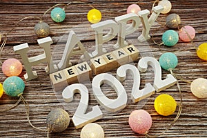 Happy New year 2022 alphabet letter with LED cotton balls decoration on wooden background