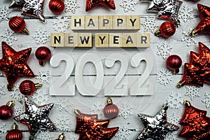 Happy New Year 2022 alphabet letters and christmas decoration on wooden background