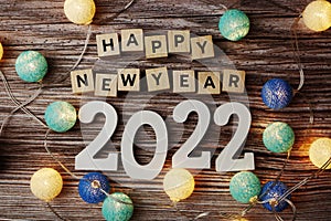 Happy New Year 2022 decorate with LED cotton ball on wooden background