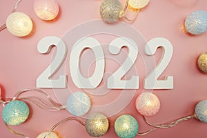 Happy New Year 2022 festive background with space on pink background