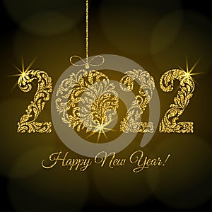 Happy New Year 2022. Figures  and Christmas ball from a floral ornament with golden glitter and sparks