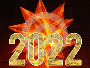 Happy New Year 2022 With Golden Shiny Text On Neon Light Darkness Background.