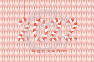 Happy New Year 2022! The numbers 2022 are in the form of sweet candies on a red knitted background. Christmas greeting card.